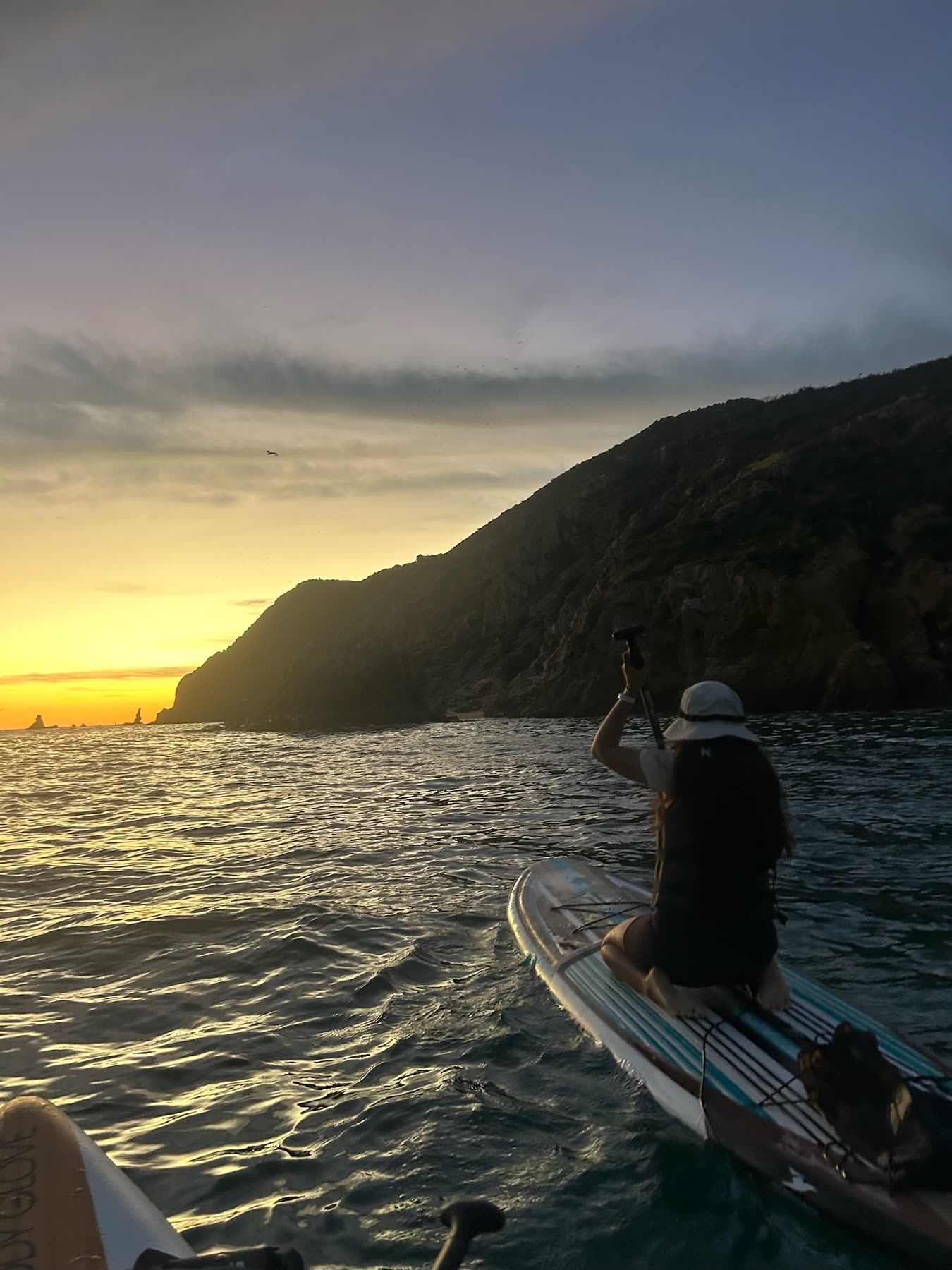 Meditating by the sea at sunset